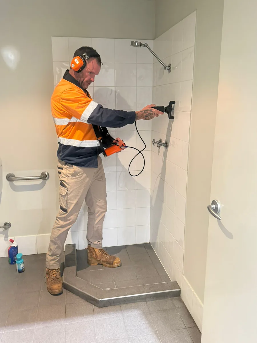 Michael using acoustic leak detection in a Perth bathroom
